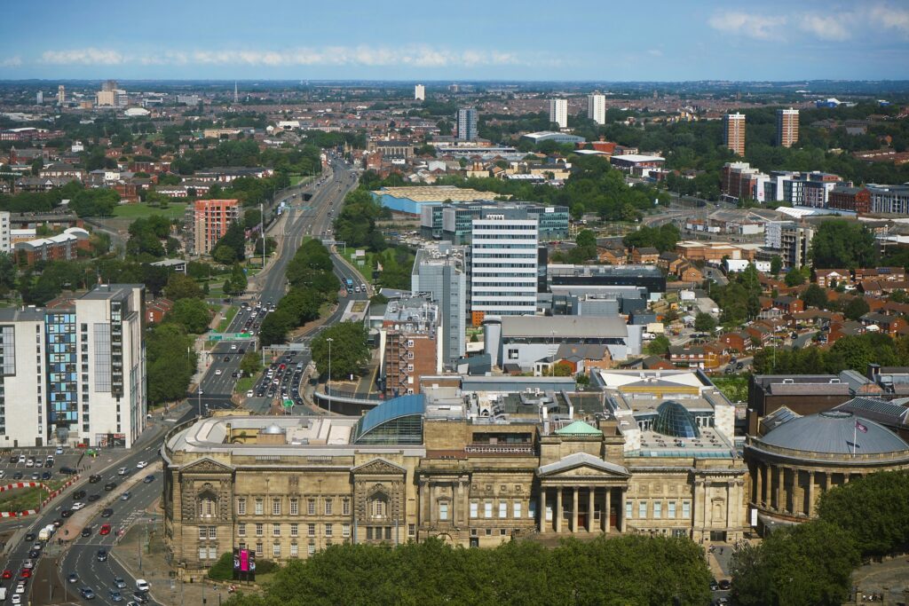 Explore the bustling cityscape of Liverpool showcasing its iconic architecture and vibrant urban life.